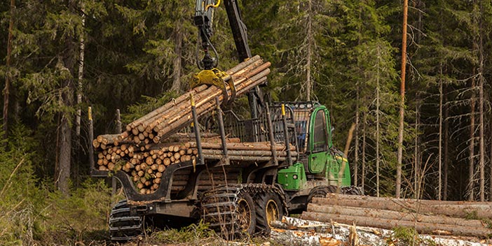 Truck lifting stacks of lumber